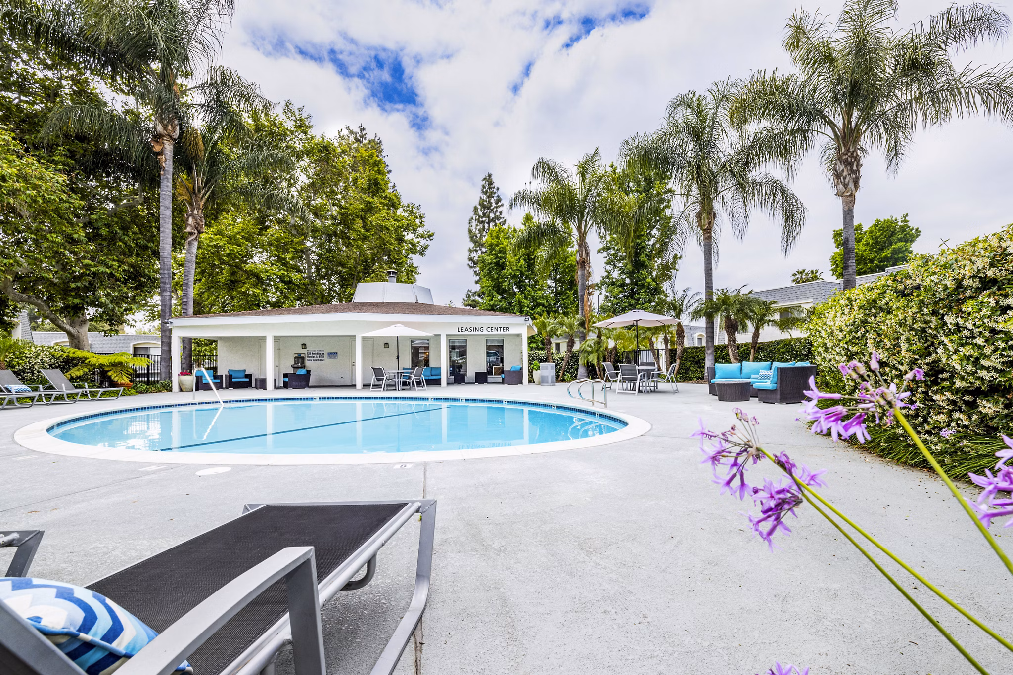 Resort-style pool with lounge chairs at Lexington Townhomes Apartments