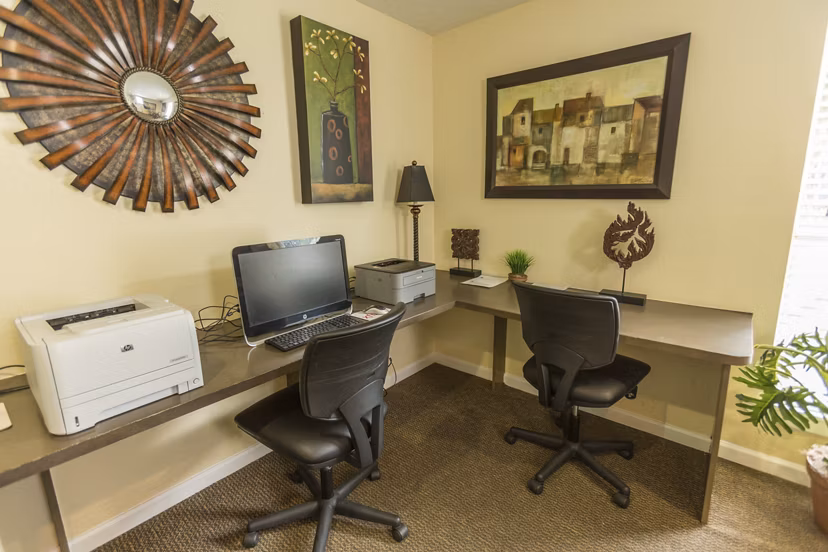 Business center with modern workstations at Scotland Yard Apartments