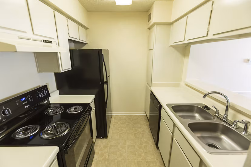 Modern kitchen with sleek countertops and stainless steel appliances at Scotland Yard Apartments