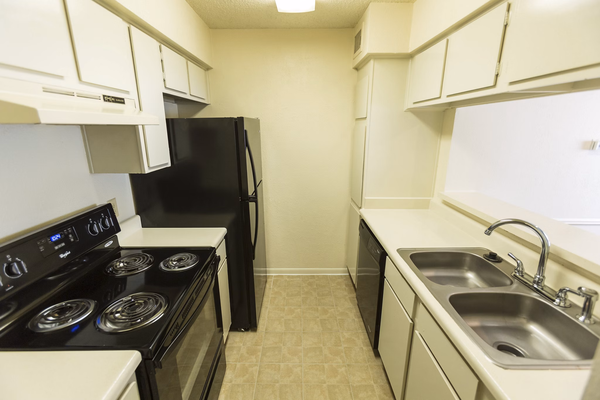 Modern kitchen with sleek countertops and stainless steel appliances at Scotland Yard Apartments