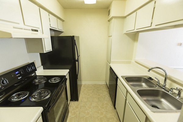 Modern kitchen with sleek countertops and stainless steel appliances at Scotland Yard Apartments