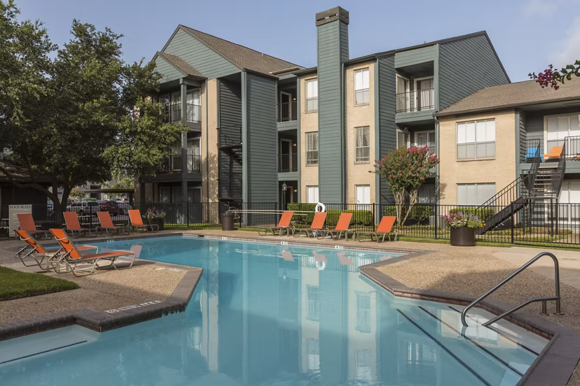 Resort-style pool at Scotland Yard Apartments offering luxury lounging areas