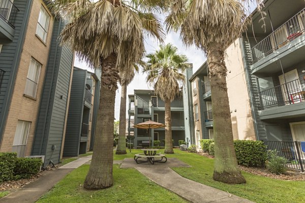 Courtyard with lush landscaping and seating areas at Scotland Yard Apartments in a Greystar luxury community