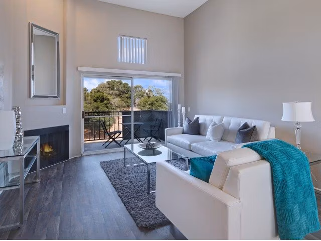 Spacious living room with modern decor and ample natural light at Canyon Crest Apartments