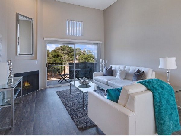 Spacious living room with modern decor and ample natural light at Canyon Crest Apartments