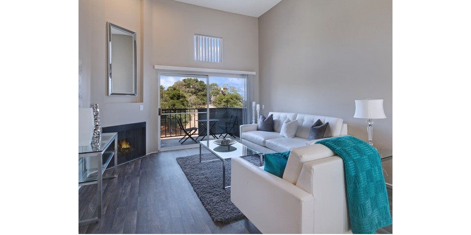 Spacious living room with modern decor and ample natural light at Canyon Crest Apartments