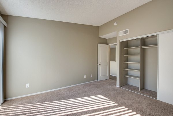 Cozy bedroom with modern furnishings at Canyon Ridge Apartments, offering luxury living in a serene environment