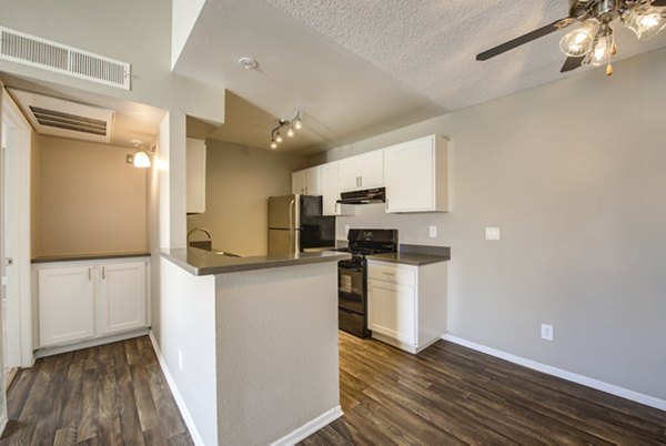 Kitchen featuring modern stainless steel appliances and granite countertops in Canyon Ridge Apartments