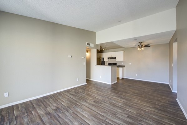 Spacious living room with modern furnishings in Canyon Ridge Apartments, featuring a cozy ambiance and large windows for natural light