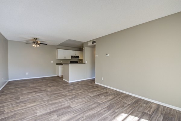 Modern living room with plush seating and large windows at Canyon Ridge Apartments, offering luxury living