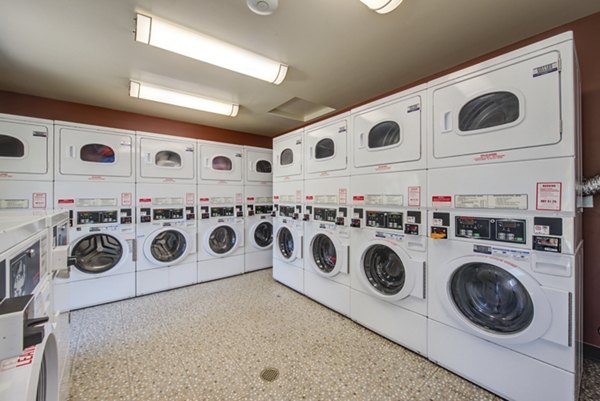 Modern laundry facility with high-efficiency machines at Canyon Ridge Apartments