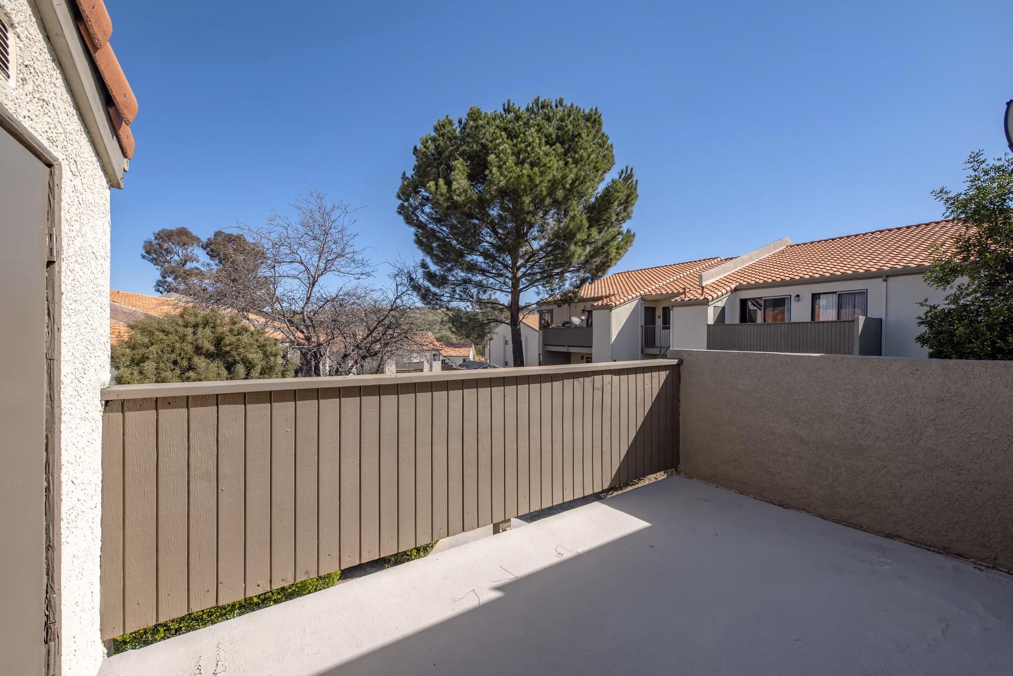 Patio with stylish outdoor seating and lush greenery at Canyon Ridge Apartments