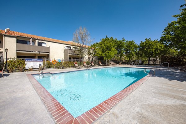 Relaxing pool area with spacious lounging deck at Canyon Ridge Apartments, offering luxury living in a serene environment