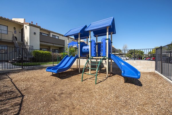 Modern playground with colorful equipment at Canyon Ridge Apartments, a Greystar property designed for family-friendly outdoor fun