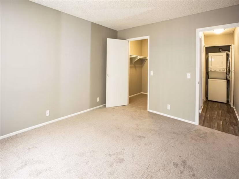Cozy bedroom with waterfront views at Harborview Apartments, featuring elegant decor and natural lighting
