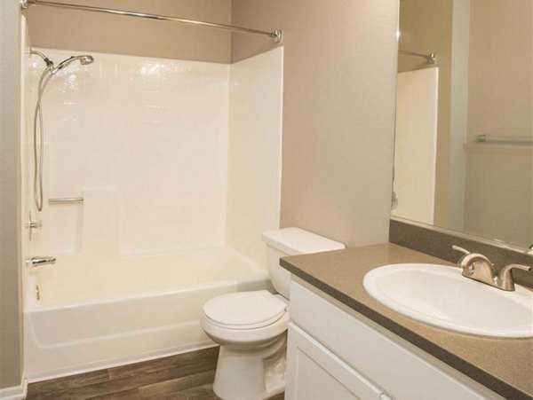 Bathroom with modern fixtures and marble countertop at Harborview Apartments in luxury community