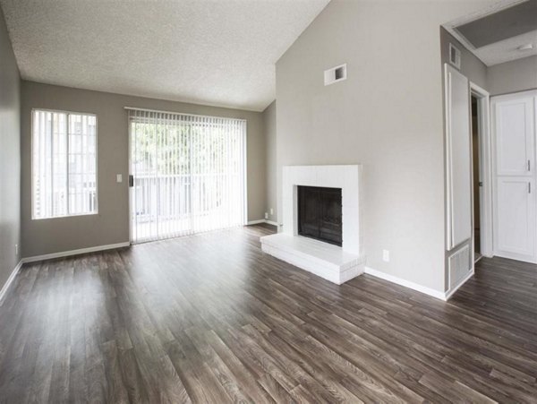 Spacious living room with waterfront views at Harborview Apartments, luxury Greystar property