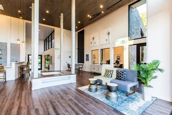Vicino Apartments: Stylish clubhouse with modern furnishings and large seating areas, perfect for community gatherings