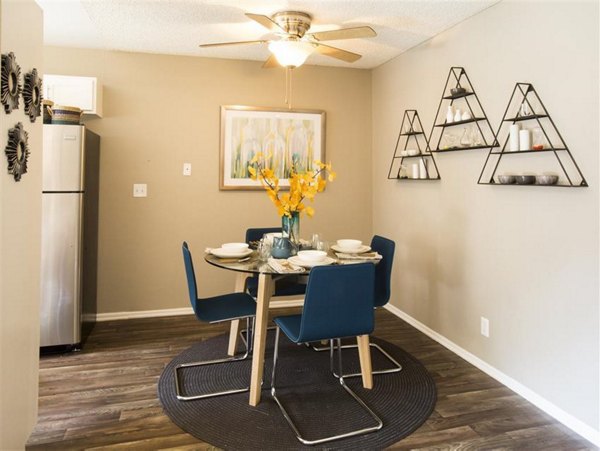 Dining area featuring modern furniture and elegant lighting at Vicino Apartments