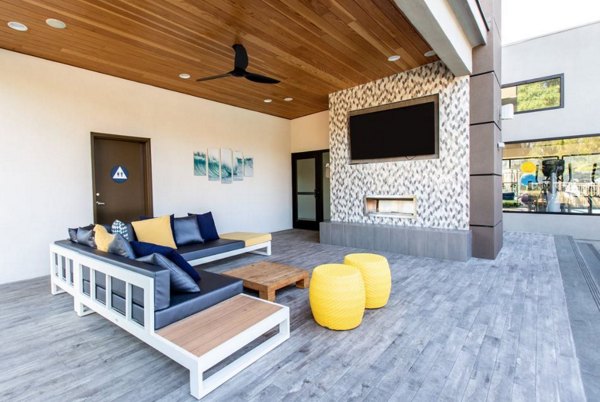 Vicino Apartments: Elegant patio featuring modern furniture and lush greenery for luxury outdoor living