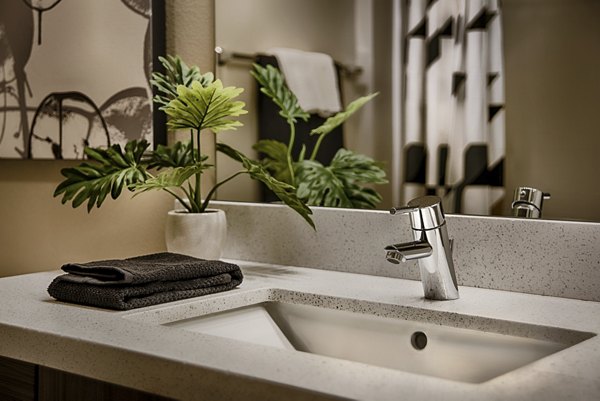 Bathroom with modern fixtures and ample lighting at Summerly at Zanjero Apartments