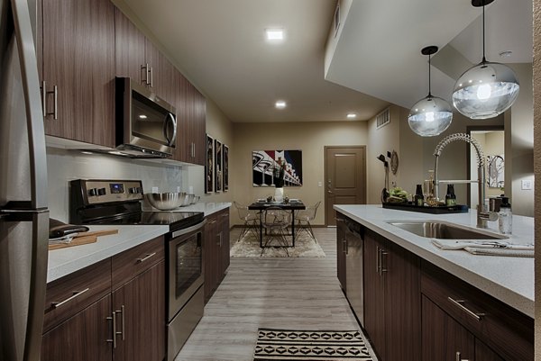 Modern kitchen featuring stainless steel appliances at Summerly at Zanjero Apartments