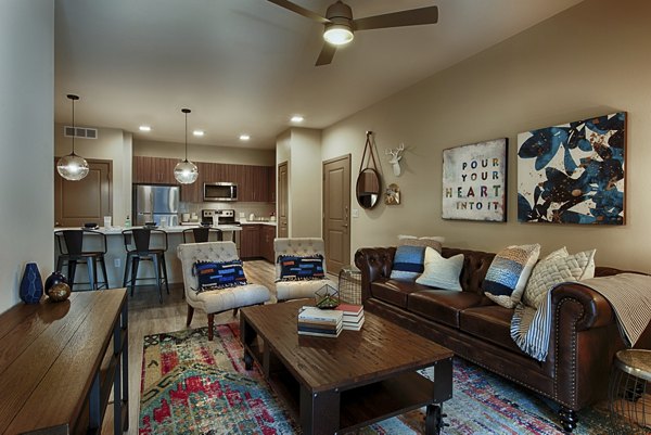 Modern living room with cozy seating and stylish decor at Summerly at Zanjero Apartments luxury community