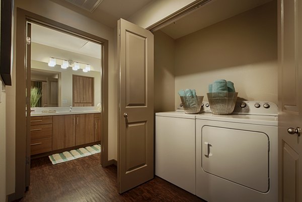 Modern laundry room with energy-efficient washers and dryers at Summerly at Zanjero Apartments