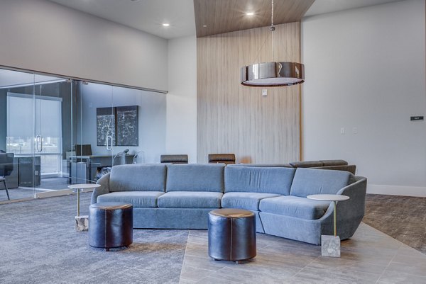 Modern clubhouse with plush seating and large TV at Anthology Apartments