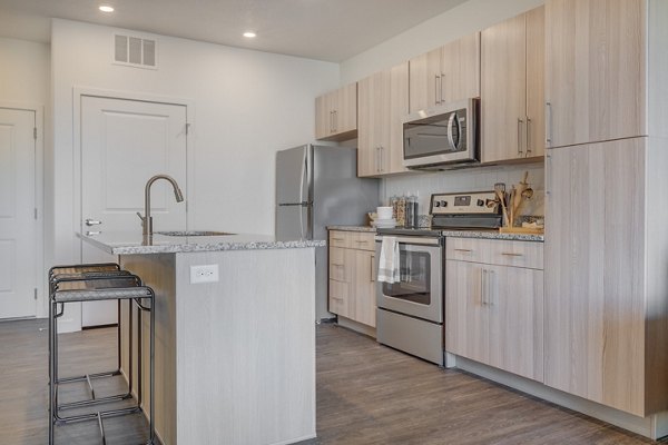 Modern kitchen with stainless steel appliances in Anthology Apartments