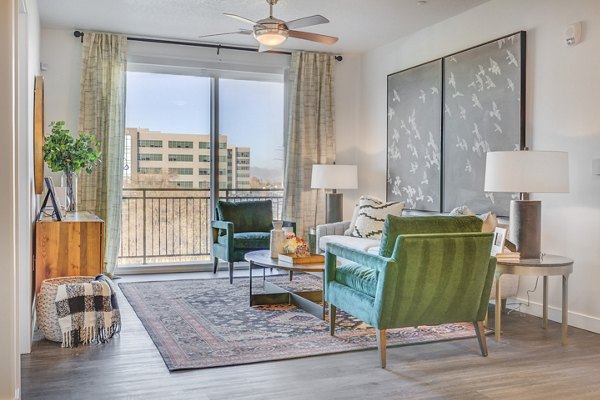 Spacious living room with contemporary decor and large windows in Anthology Apartments, a Greystar luxury property