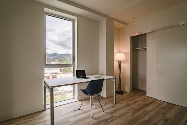 Contemporary bedroom with sleek furnishings at 47Hundred Apartments, featuring luxurious bedding and modern design