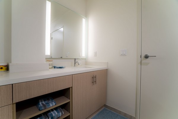 Elegant bathroom with marble countertops and modern fixtures at 47Hundred Apartments