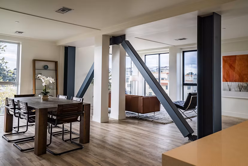 Dining area with modern decor and ample seating in 47Hundred Apartments, ideal for hosting gatherings and enjoying meals in style