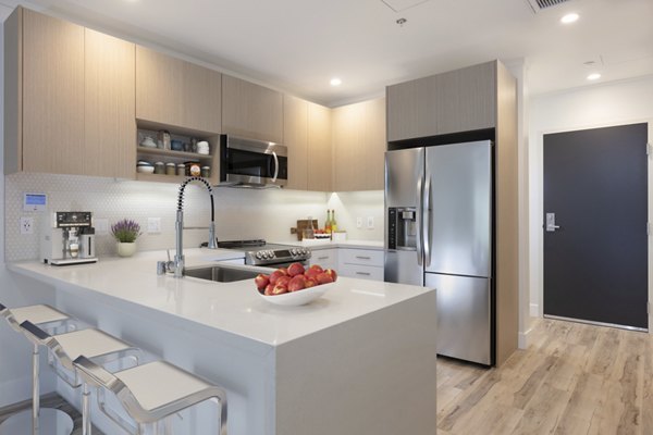 47Hundred Apartments: Contemporary kitchen featuring stainless steel appliances and modern cabinetry