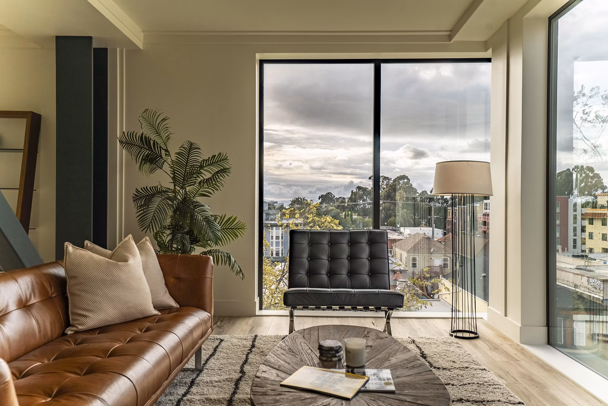 Stylish living room with modern decor and large windows at 47Hundred Apartments