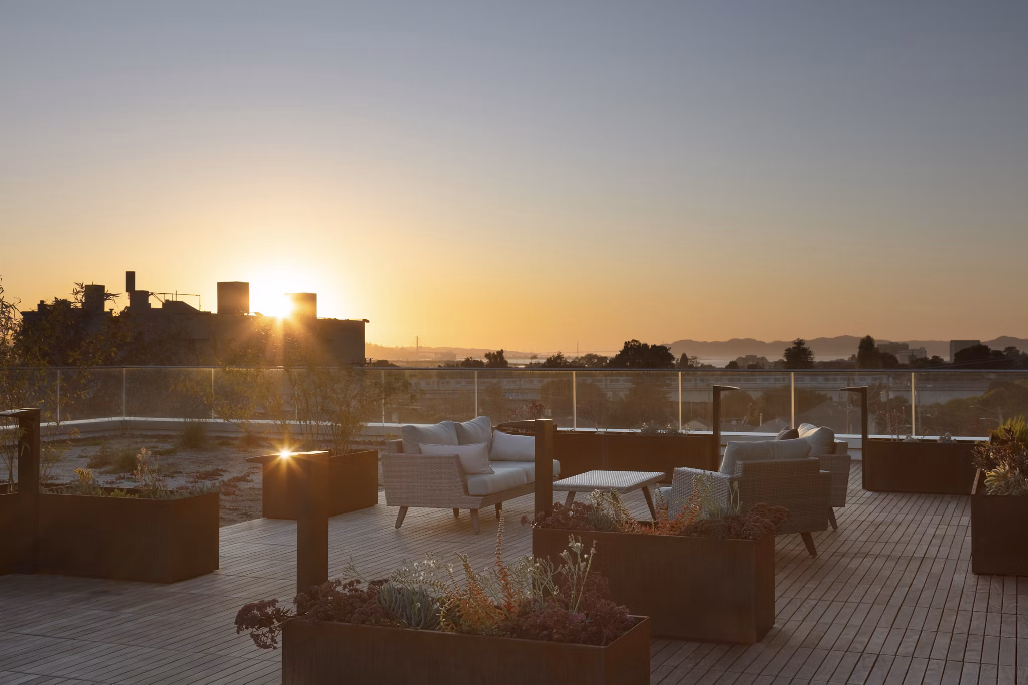 Rooftop deck with modern seating and skyline views at 47Hundred Apartments