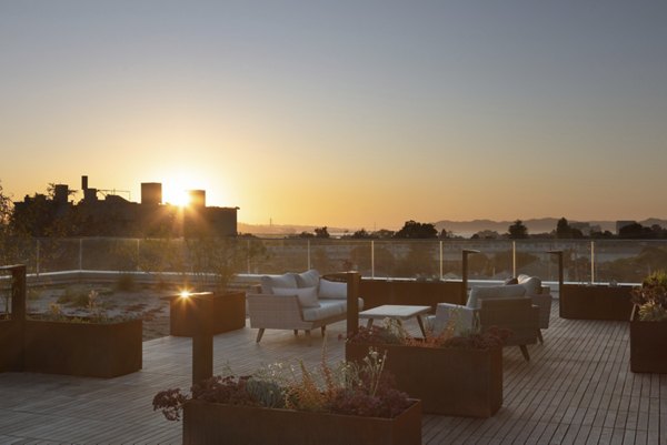 Rooftop deck with modern seating and skyline views at 47Hundred Apartments