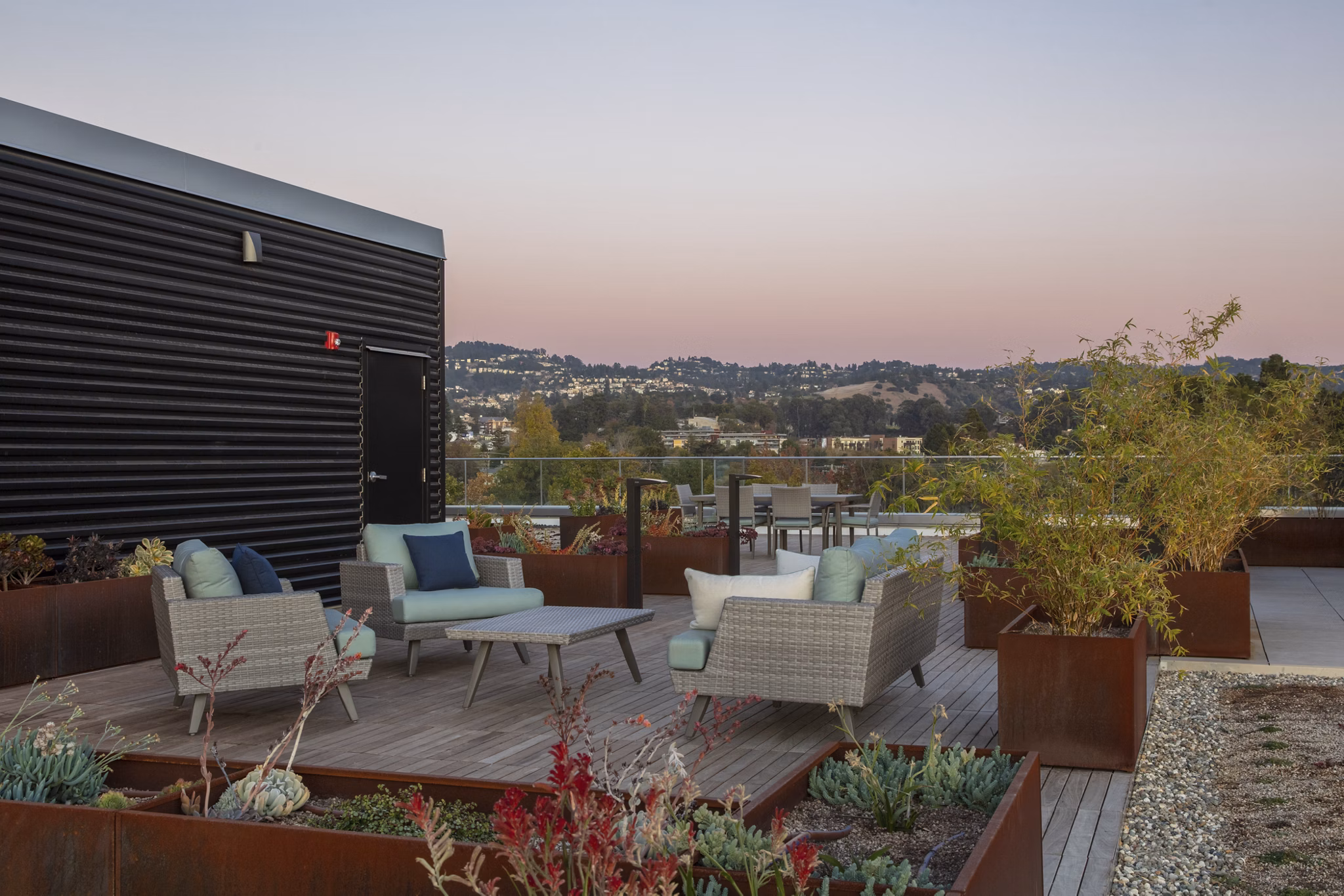 Modern rooftop deck with lounge seating at 47Hundred Apartments offering city views