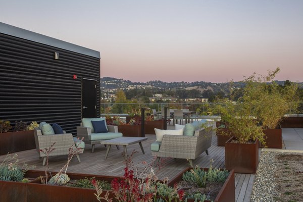 Modern rooftop deck with lounge seating at 47Hundred Apartments offering city views