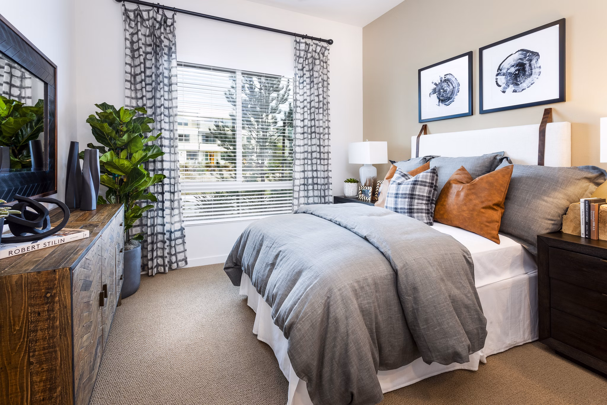 Rivue Apartments: Cozy bedroom with contemporary decor and ample natural light