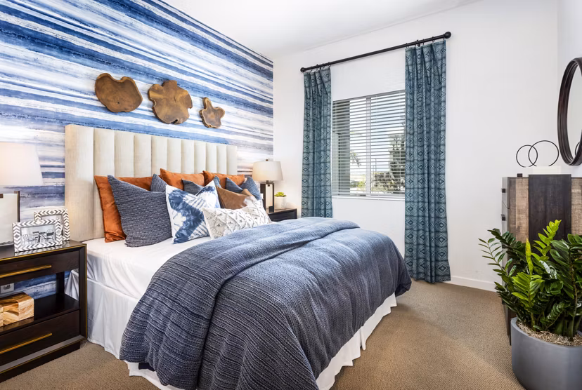 Cozy bedroom with modern decor at Rivue Apartments