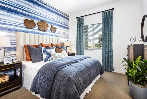 Cozy bedroom with modern decor at Rivue Apartments