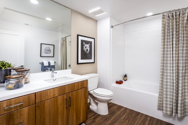 Bathroom with marble countertops and glass shower at Rivue Apartments, luxurious features in modern setting