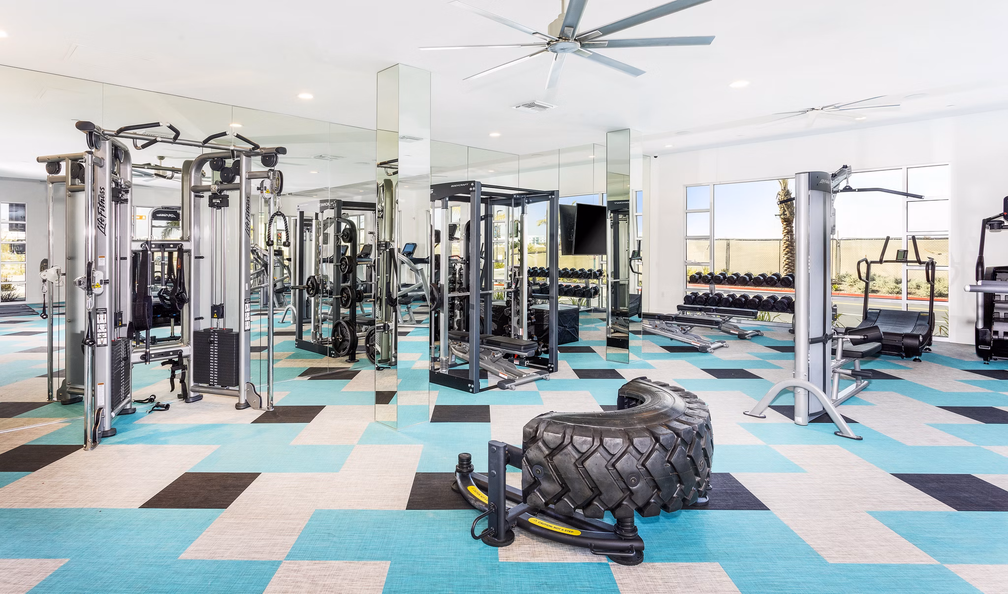Fully-equipped fitness center with modern machines at Rivue Apartments
