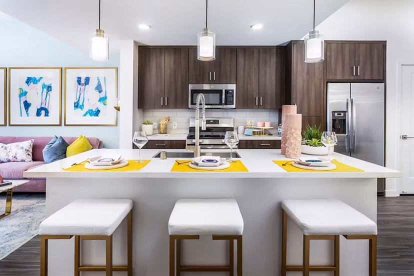 Modern kitchen with marble countertops and stainless steel appliances in Rivue Apartments, Greystar luxury community