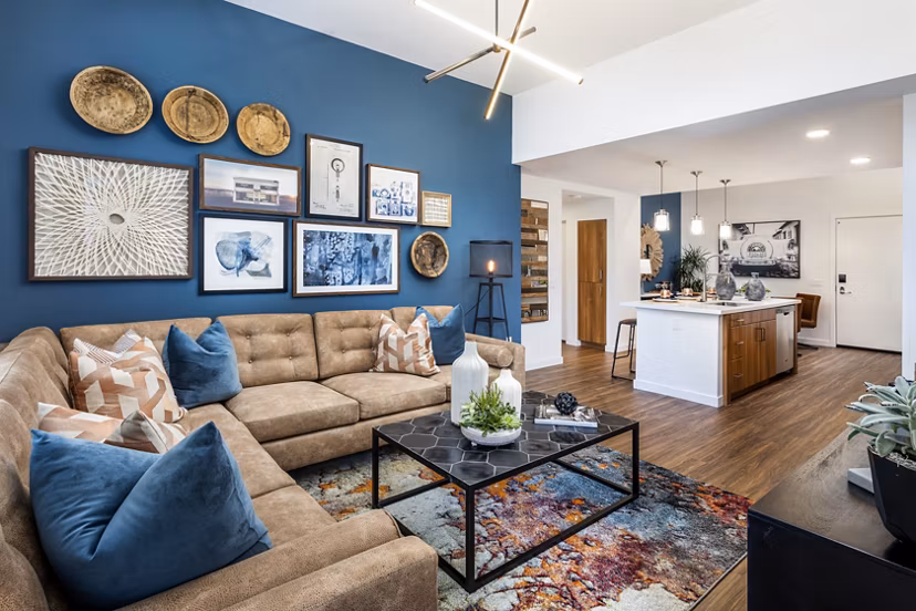 Spacious living room with modern decor and large windows in Rivue Apartments, luxury residences by Greystar