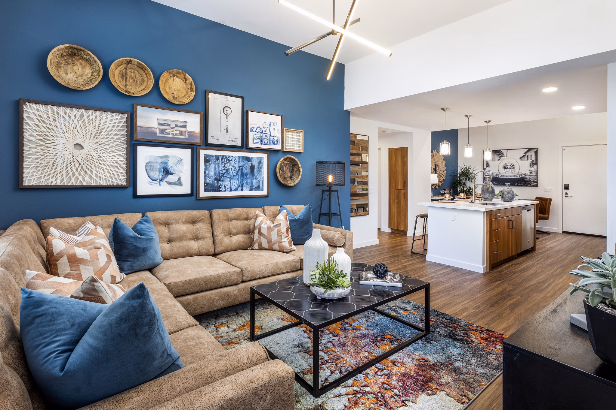 Spacious living room with modern decor and large windows in Rivue Apartments, luxury residences by Greystar