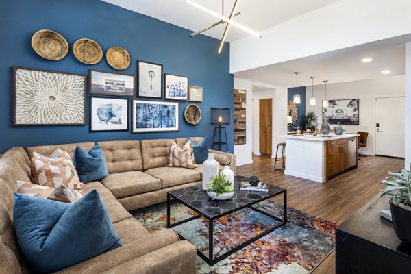 Spacious living room with modern decor and large windows in Rivue Apartments, luxury residences by Greystar