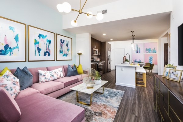 Spacious living room with modern decor at Rivue Apartments